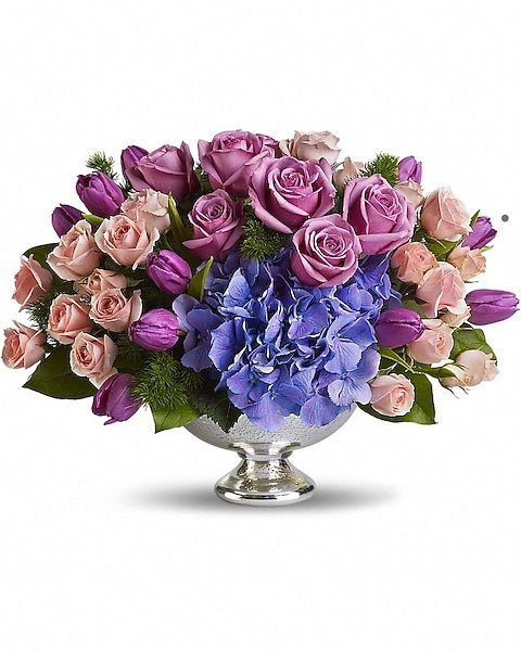 Mixed pink and purple flower arrangement in silver bow
