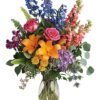 Orange lilies with purple accent flowers arranged by Gurnee florist