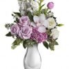 : White and lavender floral arrangement in glass vase