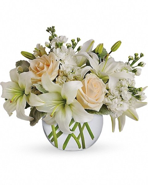 White lilies and pink roses in a round vase from florist in Grayslake IL