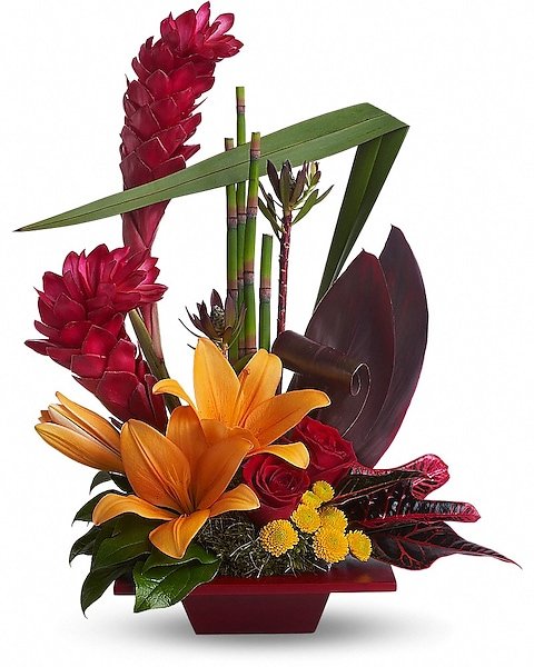 Tropical floral arrangement with orange lilies and red accents from florist in Waukegan IL