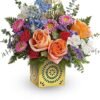 Mixed colorful roses in a yellow vase from florist in Grayslake IL