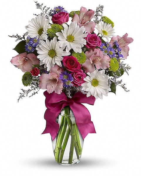 Bright mixed flower arrangement in modern glass vase