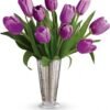 Purple tulip bouquet in clear glass vase