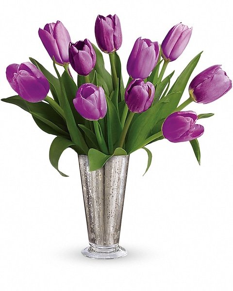 Purple tulip bouquet in clear glass vase