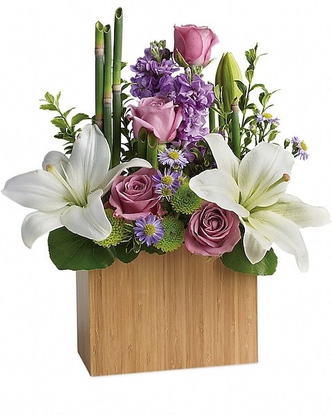 White lilies and purple roses in a wooden vase, available from Gurnee florist