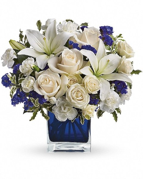White rose and lily bouquet in square glass vase