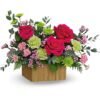 Red rose and greenery bouquet in a pink vase from the best florist in Gurnee IL