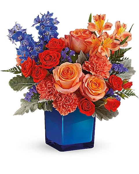 : Red white and blue mixed flower arrangement in truck planter