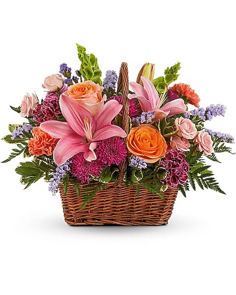 Pink lily and rose basket flower arrangement