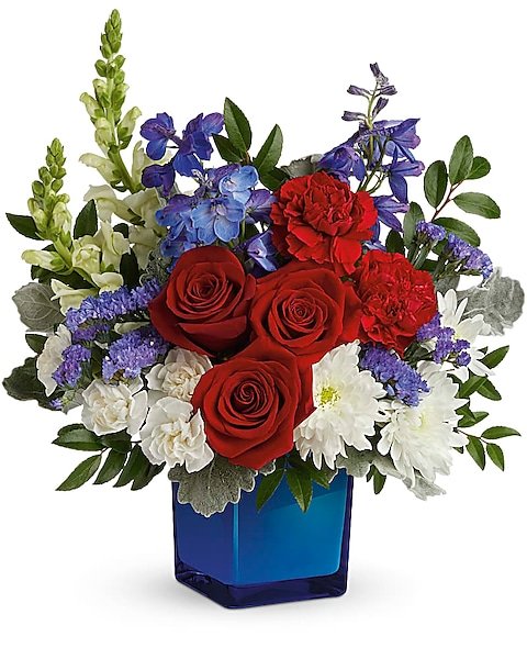 Red rose and white lily bouquet with blue accents
