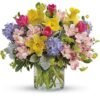 Colorful spring flower bouquet in clear glass vase