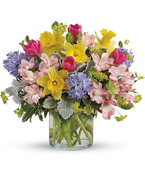 Colorful spring flower bouquet in clear glass vase