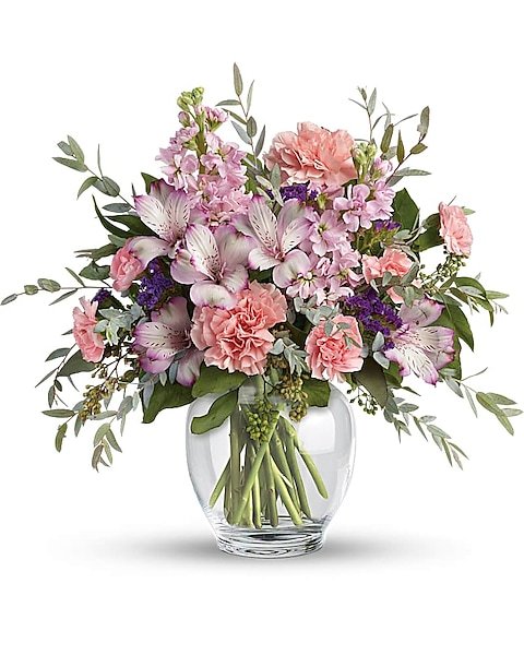 Soft pink mixed flower bouquet in clear glass vase