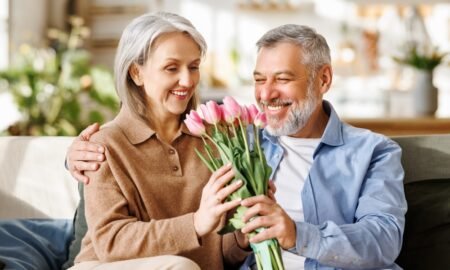Couple celebrating their anniversary with a bouquet from our Gurnee Flower Shop.