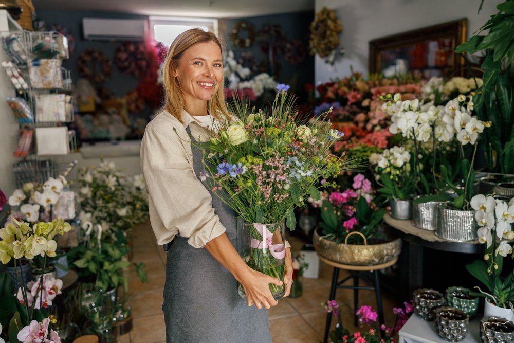 Woman holding large pink peony bouquet