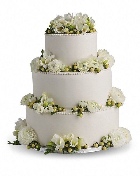 Three-tier wedding cake with white floral arrangements available in Gurnee