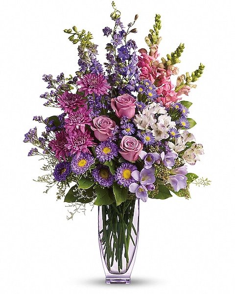 Elegant garden-style floral arrangement with purple and pink blooms from Grayslake florist
