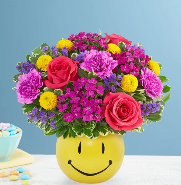 Cheerful bright floral bouquet with smiley vase by the best florist in Gurnee IL