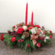 Christmas floral centerpiece with candles from florist in Grayslake IL