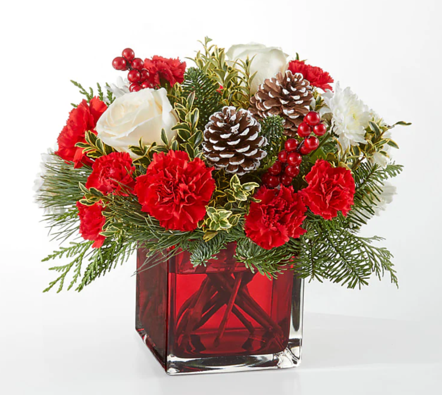 Red and white holiday bouquet with pine accents from the best florist in Gurnee IL
